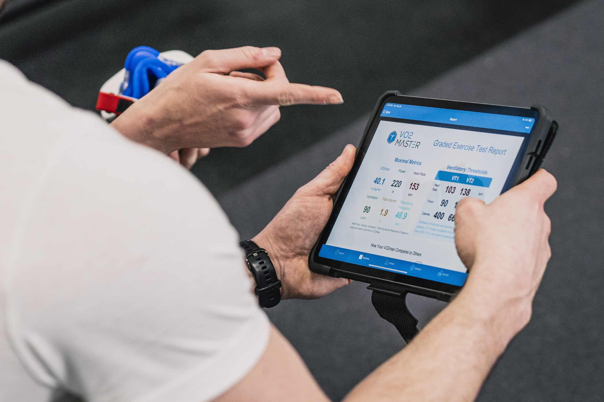 Coach and athlete viewing a VO2 Master exercise test report on a tablet