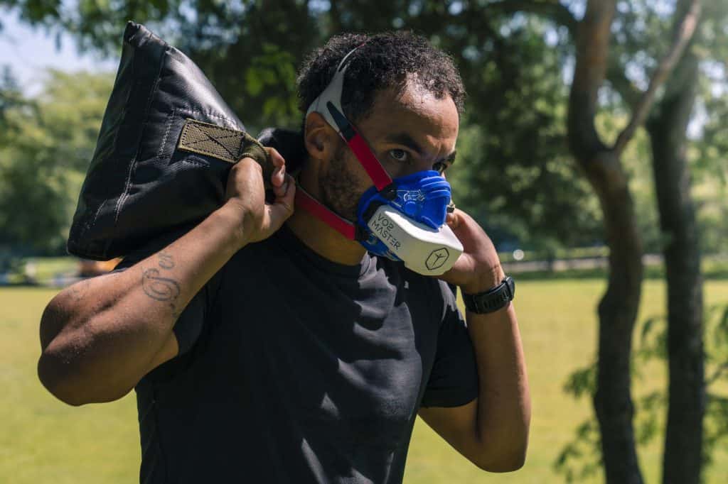 Military professional carrying sandbag on his back wearing the analyzer