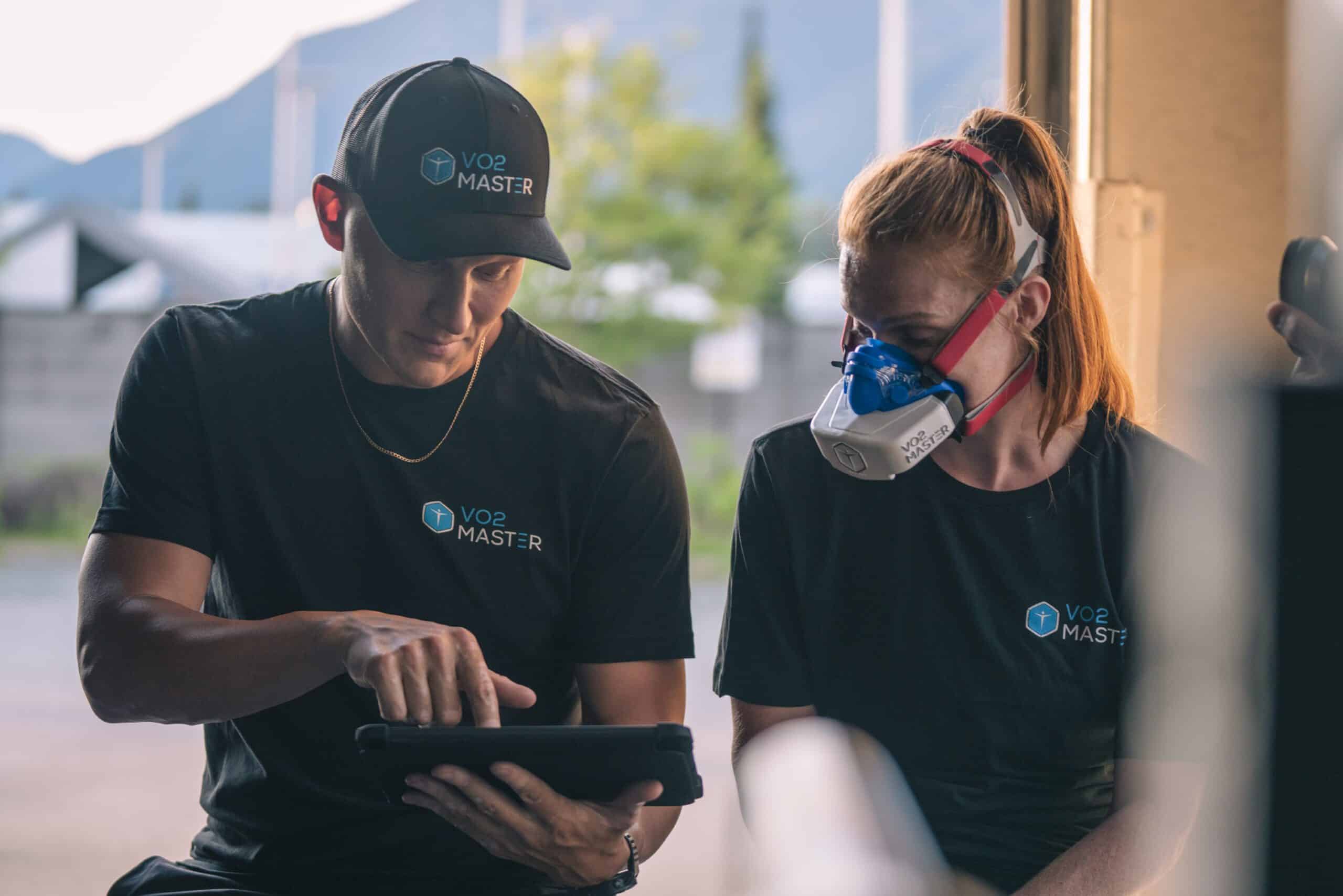 Man showing VO2 Max report to women in testing
