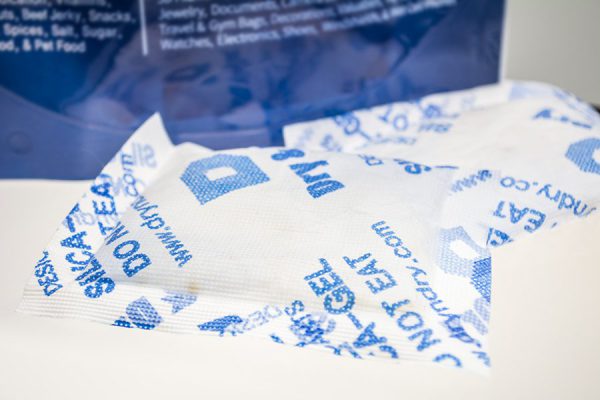 Up close shot of multiple desiccant pouches and bag in the background