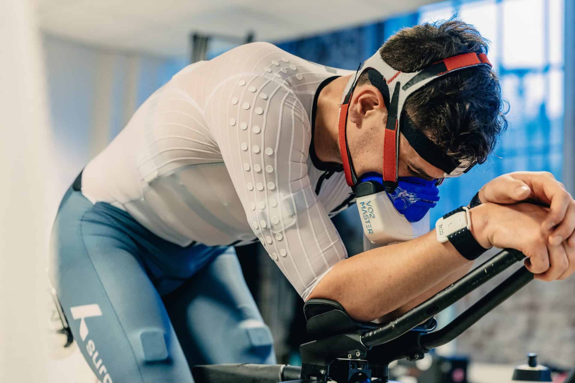Man on training bike wearing VO2 Master while training for or a Triathlon