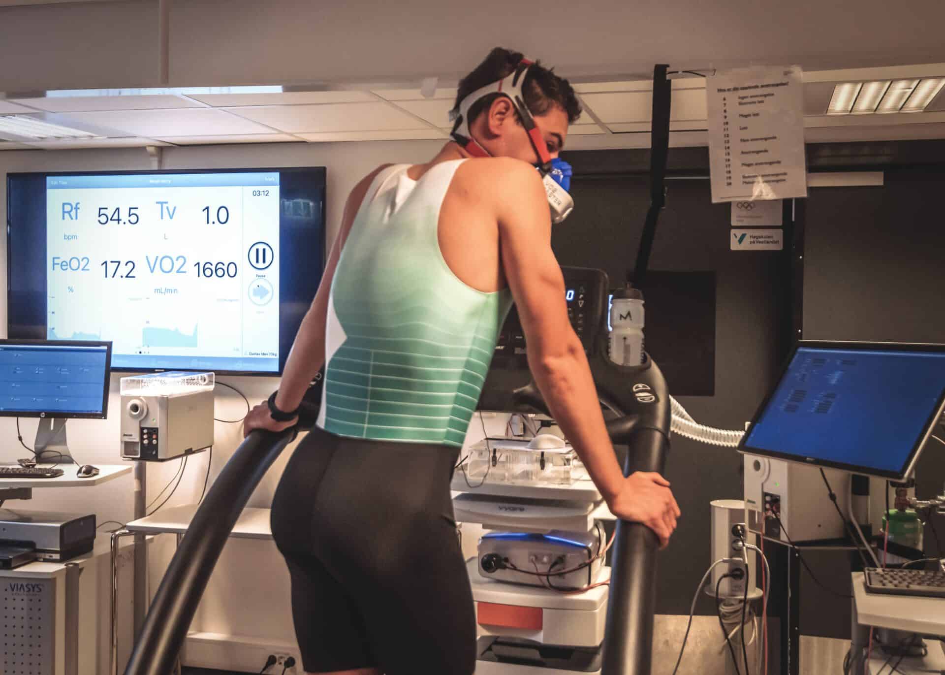 Athlete standing on a treadmill with the VO2 Master on.