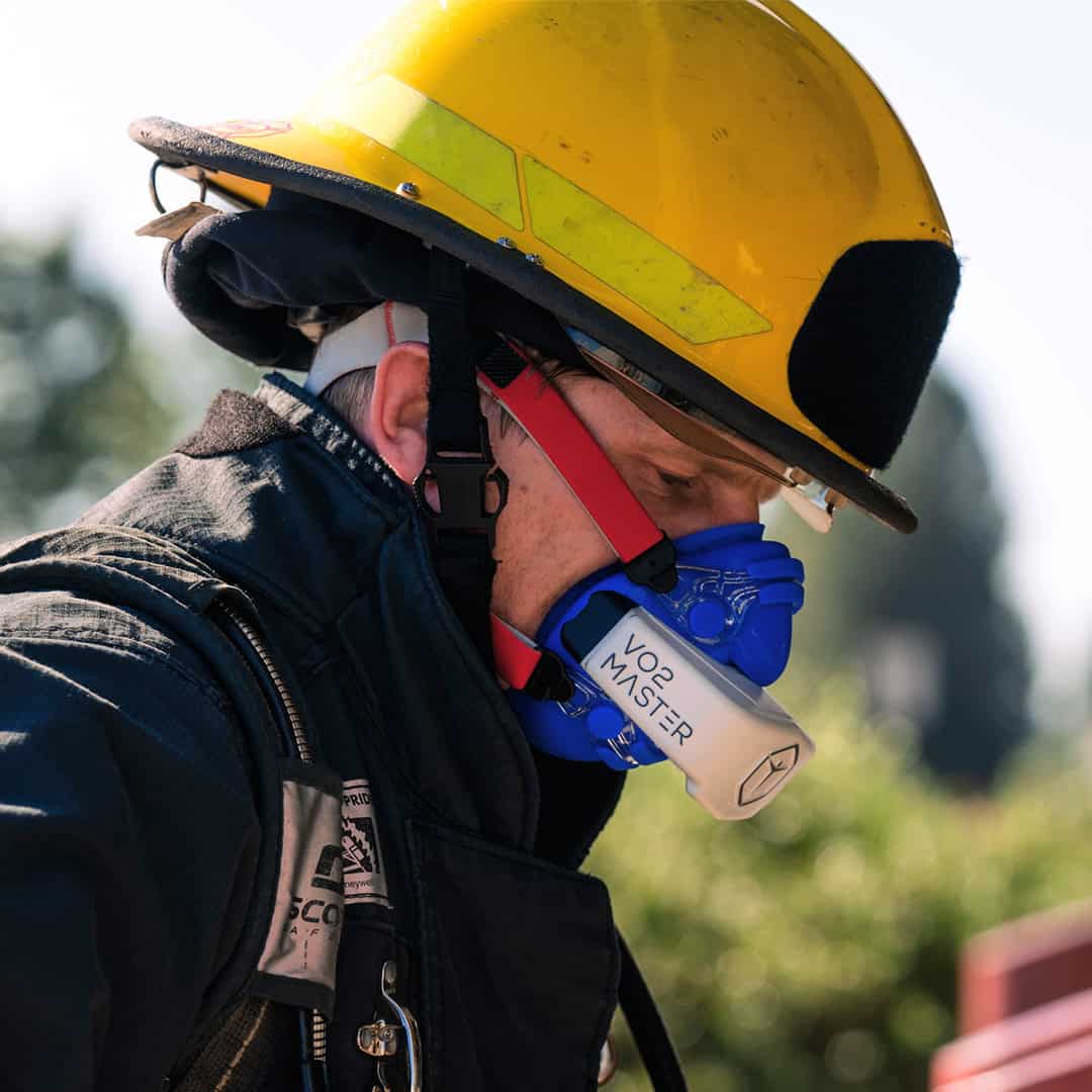 a firefighter using a portable metabolic analyzer in the field for training and testing rather than a traditional lab cart
